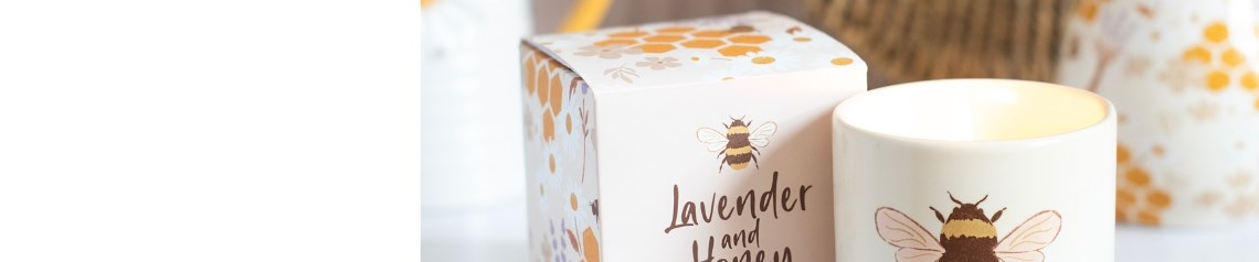 Honey Bee collection of wholesale mugs, candles, socks, bags and home accessories with bee, honeycomb and lavender floral motifs in yellow, cream and lilac.