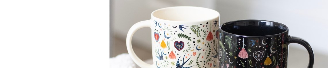 Wholesale Midnight Bloom folk art homeware and gifts featuring heart, bird and floral designs. This collection includes patterned mugs, scented candles, stationery and decorative oil burners in cream and black. Ideal wholesale giftware for shops, online retailers and lifestyle stores. No minimum order and worldwide shipping.