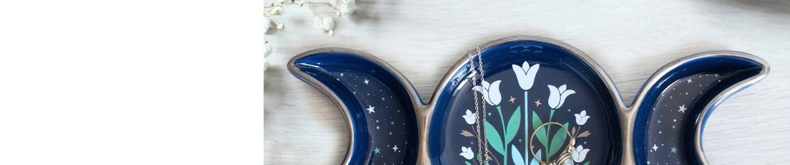 Triple Moonflower wholesale celestial gift collection featuring midnight blue moonflower designs, triple moon symbols, goddess-inspired decor, mugs, oil burners, incense, journals, jewellery, ornaments and spiritual accessories.