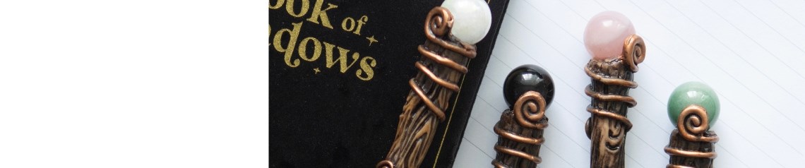 A magical stationery and giftware collection featuring crystal wand pens, velvet-effect notebooks, and crystal bookmarks. The range includes rich purple, green, burgundy, and black designs themed around energy, abundance, love, and protection. Ideal for gift shops or metaphysical retailers.